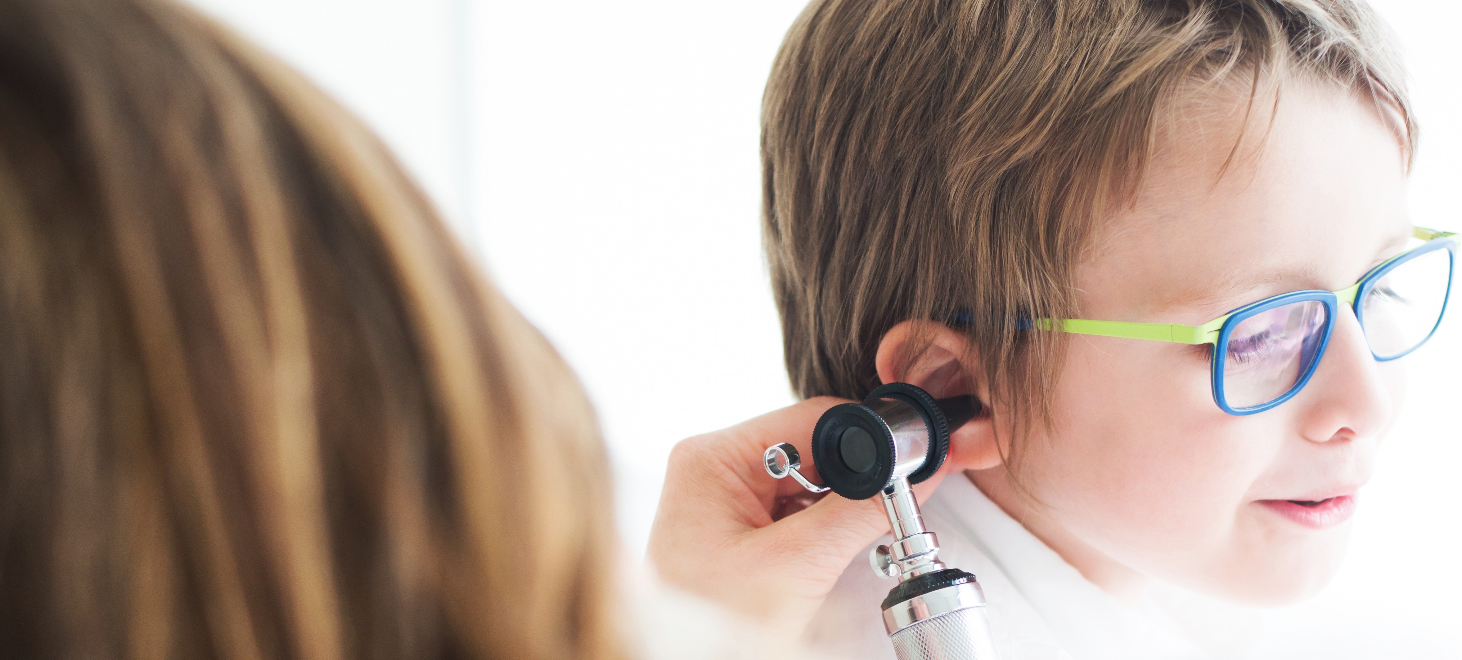 Provider examining a child's ear