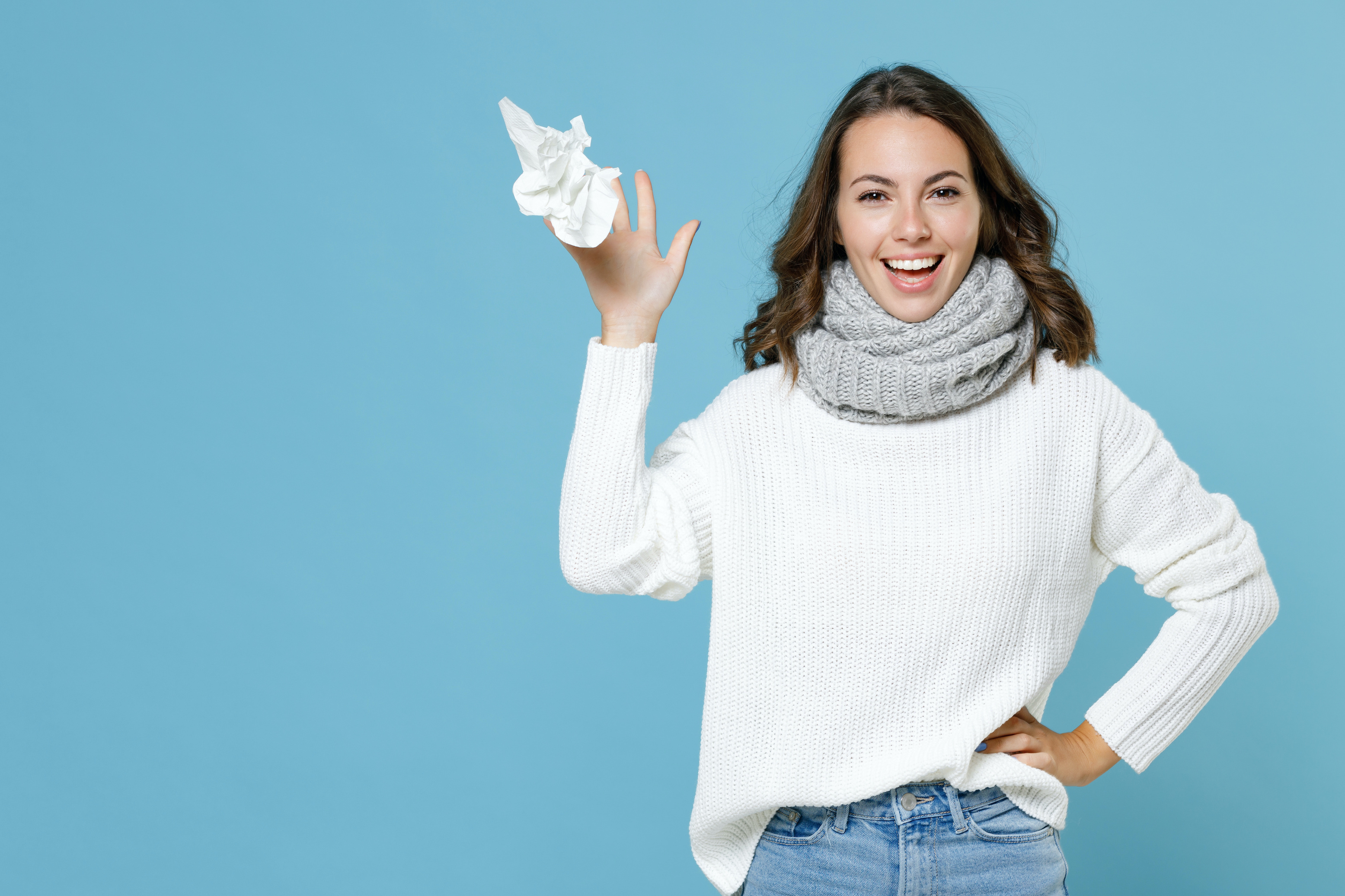 Happy woman tossing her tissue up in the air