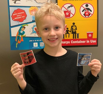 Logan showing off the stickers he got after his first round of allergy shots.