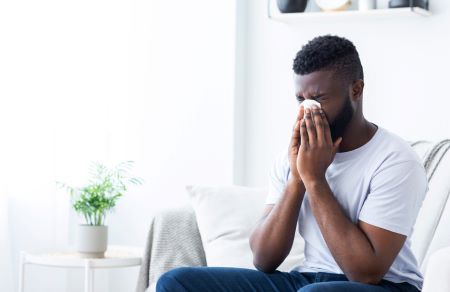 Man blowing his nose