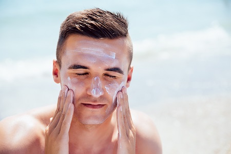 Man applying sunscreen