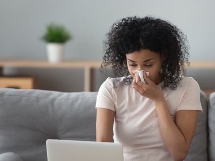 Woman blowing her nose